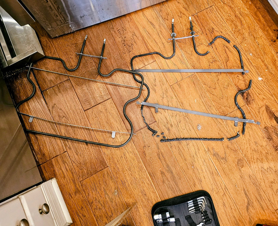 New bake heating element next to an old burned-out one